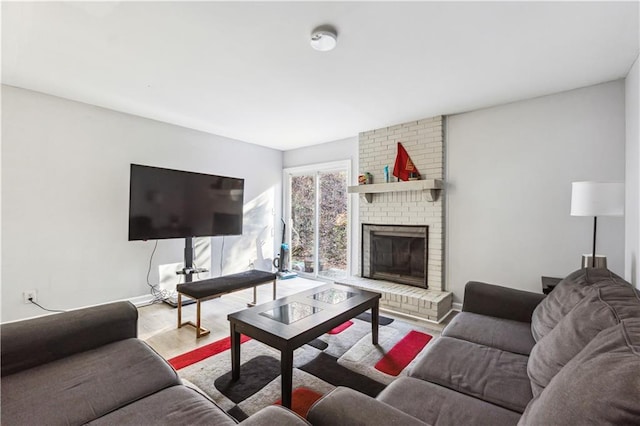 living room featuring wood-type flooring and a brick fireplace