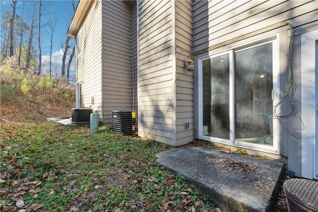 view of side of property with central air condition unit