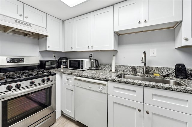 kitchen with light stone countertops, white appliances, sink, light hardwood / wood-style flooring, and white cabinets