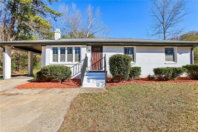 ranch-style home with a carport and a front lawn