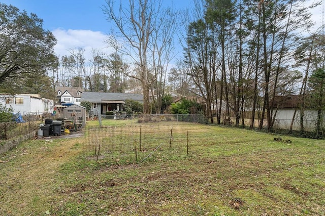 view of yard featuring an outbuilding, an exterior structure, and fence