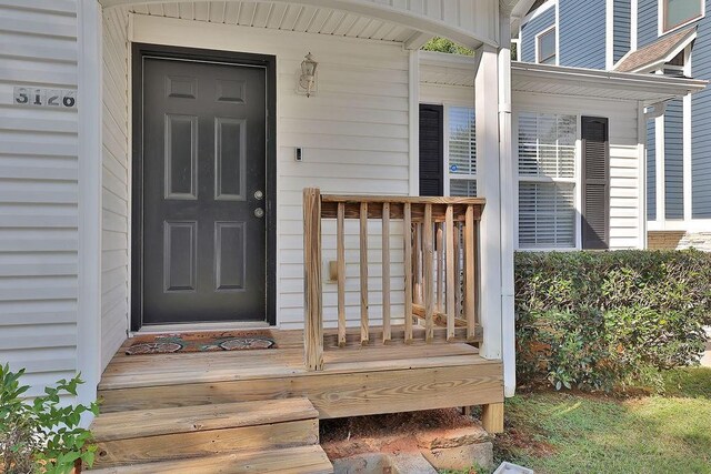 view of exterior entry featuring covered porch