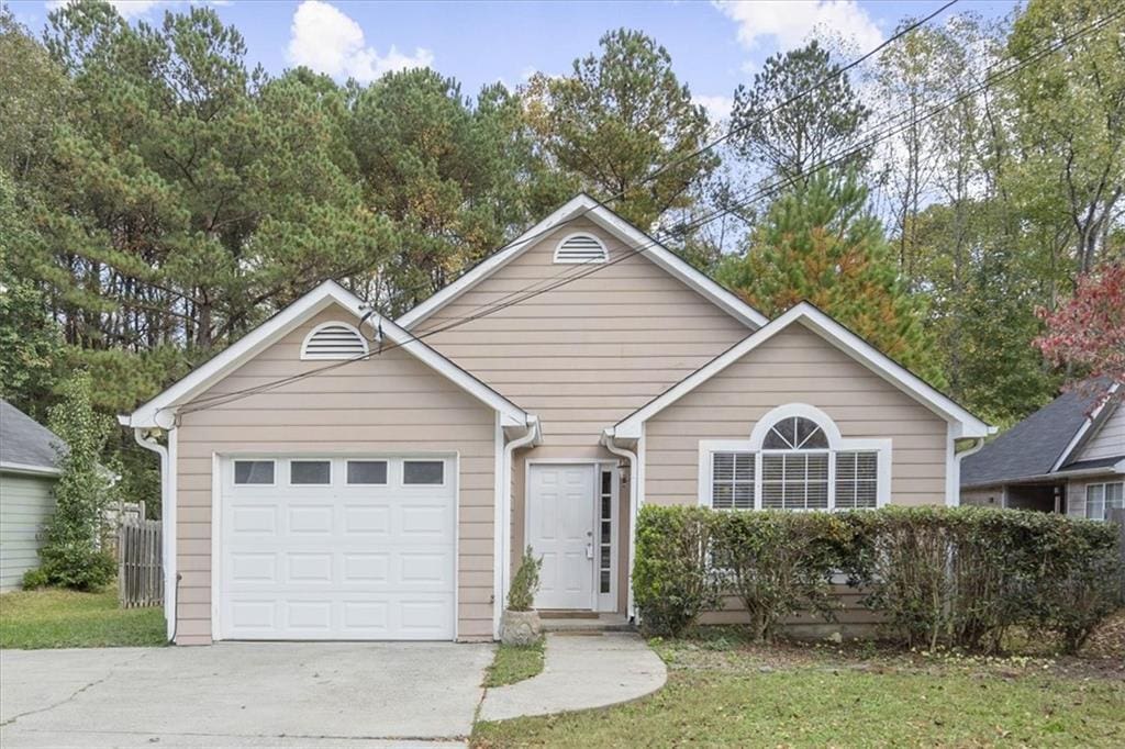 view of front of house with a front lawn and a garage