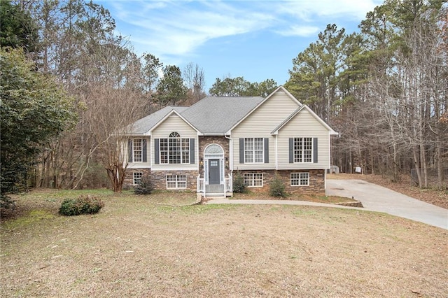 bi-level home with a front lawn