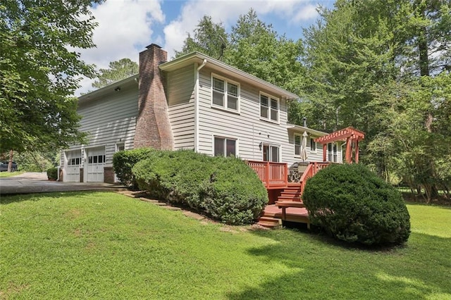1487 W Bend Creek Ct, Atlanta, GA 30338 - back of property featuring a chimney, a wooden deck, a garage, asphalt driveway, and a lawn