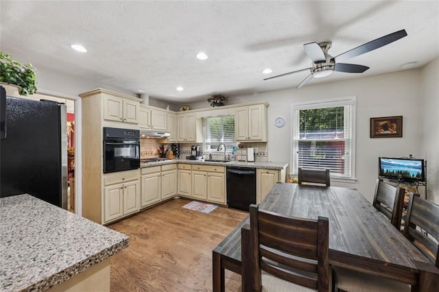 1487 W Bend Creek Ct, Atlanta, GA 30338 - kitchen with black appliances, cream cabinets, a sink, light wood-style floors, and ceiling fan