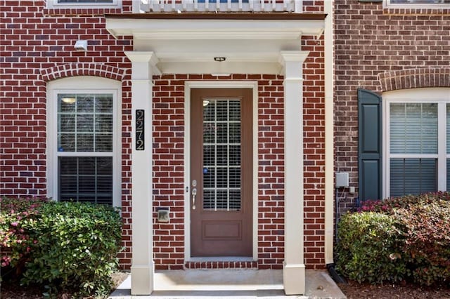 doorway to property with brick siding