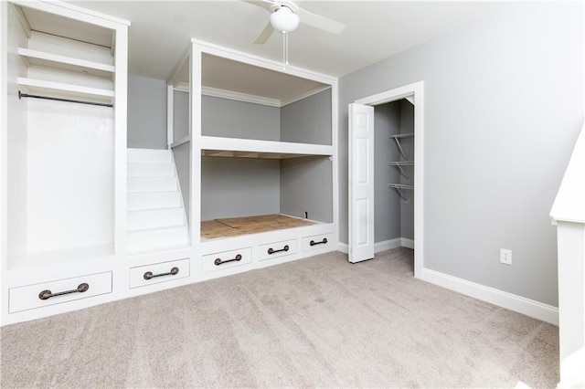 interior space featuring a closet, light colored carpet, and ceiling fan