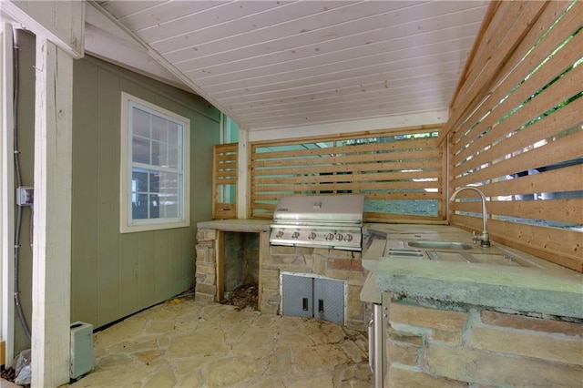 view of patio with exterior kitchen, sink, and grilling area