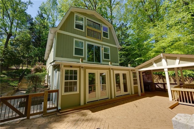 back of property with french doors and a deck