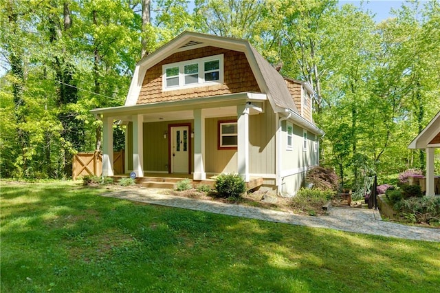 view of front of home with a porch and a front yard