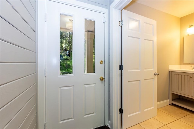 entryway with light tile patterned floors