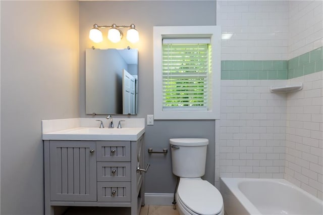 full bathroom with vanity, tiled shower / bath combo, and toilet