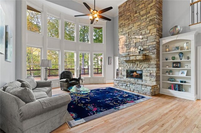 519 River Estates Parkway, Canton, GA 30115 - living area featuring ceiling fan, a fireplace, wood finished floors, and a towering ceiling