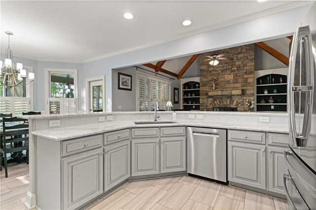 519 River Estates Parkway, Canton, GA 30115 - kitchen with gray cabinets, a fireplace, a sink, ceiling fan with notable chandelier, and stainless steel appliances