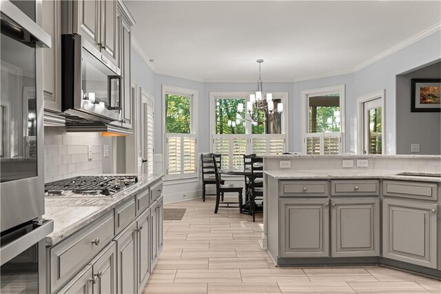 519 River Estates Parkway, Canton, GA 30115 - kitchen with decorative backsplash, a notable chandelier, a wealth of natural light, and gray cabinetry
