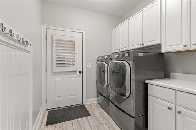 519 River Estates Parkway, Canton, GA 30115 - laundry area featuring baseboards, cabinet space, and independent washer and dryer
