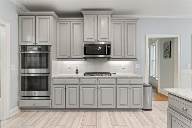 519 River Estates Parkway, Canton, GA 30115 - kitchen featuring light stone countertops, baseboards, tasteful backsplash, gray cabinetry, and stainless steel appliances