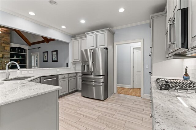 519 River Estates Parkway, Canton, GA 30115 - kitchen with lofted ceiling with beams, appliances with stainless steel finishes, a sink, gray cabinetry, and ornamental molding