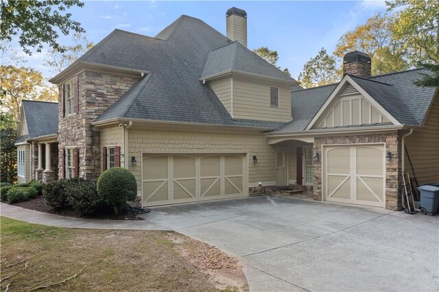 519 River Estates Parkway, Canton, GA 30115 - view of front of home with concrete driveway, an attached garage, and a chimney