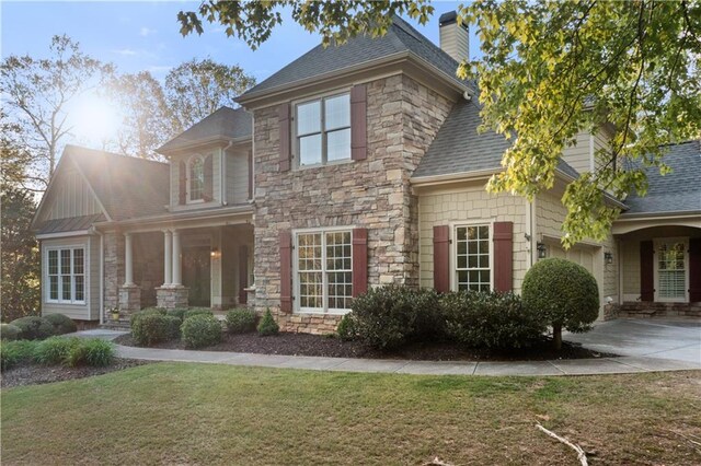 519 River Estates Parkway, Canton, GA 30115 - view of front facade with a shingled roof, an attached garage, a front lawn, stone siding, and a chimney