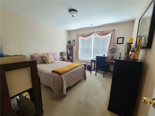 bedroom featuring light colored carpet and visible vents