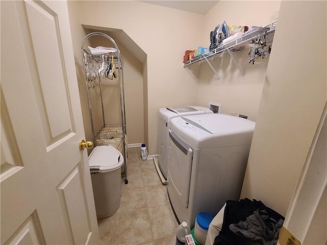 laundry area featuring laundry area, light tile patterned floors, and independent washer and dryer