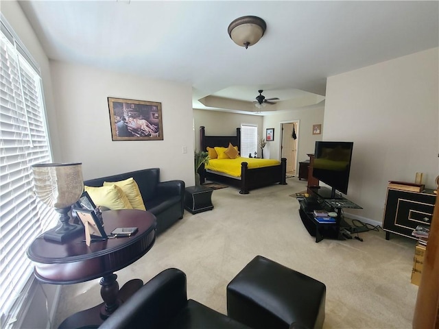 living area featuring carpet floors and ceiling fan