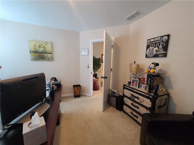 office space featuring baseboards, visible vents, and light colored carpet