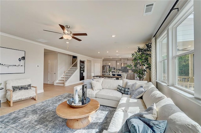 82 Sheryl Way, Loganville, GA 30052 - living area with stairway, light wood-type flooring, crown molding, recessed lighting, and ceiling fan