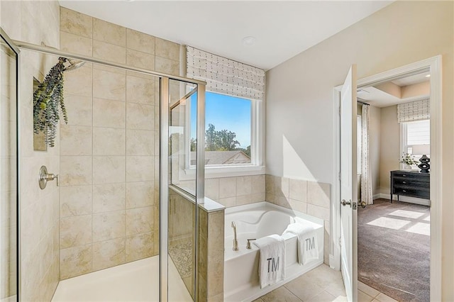 82 Sheryl Way, Loganville, GA 30052 - bathroom featuring a bath, a stall shower, and tile patterned flooring
