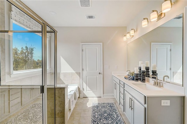 82 Sheryl Way, Loganville, GA 30052 - full bathroom featuring double vanity, a bath, tile patterned flooring, and a stall shower