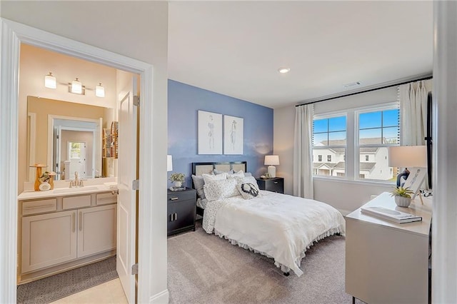 82 Sheryl Way, Loganville, GA 30052 - bedroom featuring connected bathroom, light colored carpet, and recessed lighting