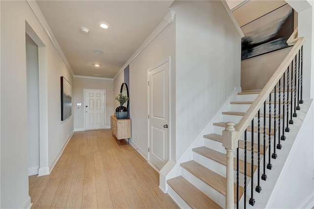 82 Sheryl Way, Loganville, GA 30052 - corridor featuring ornamental molding, light wood-style flooring, stairway, and recessed lighting