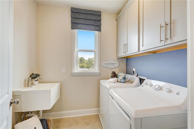 82 Sheryl Way, Loganville, GA 30052 - laundry room with separate washer and dryer, cabinet space, and light tile patterned flooring