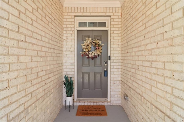 property entrance with brick siding