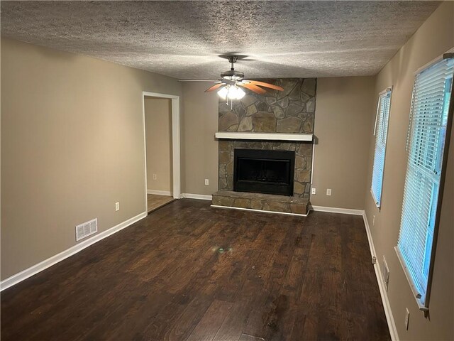 1106 Hardy Cir, Dallas, GA 30157 - unfurnished living room with visible vents, ceiling fan, a textured ceiling, a fireplace, and wood finished floors