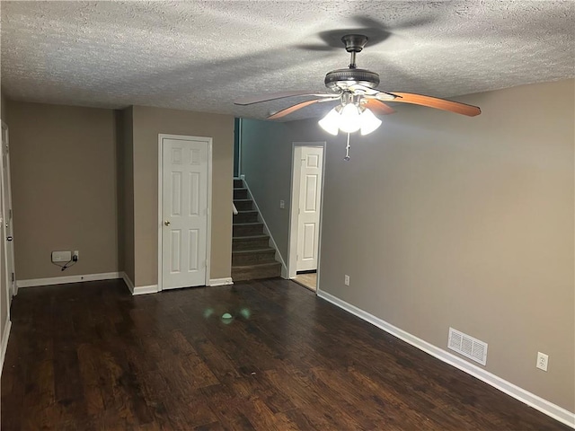 1106 Hardy Cir, Dallas, GA 30157 - spare room featuring ceiling fan, dark wood finished floors, visible vents, stairs, and baseboards