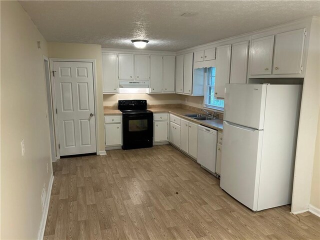 1106 Hardy Cir, Dallas, GA 30157 - kitchen with white appliances, light wood-style flooring, a textured ceiling, and exhaust hood