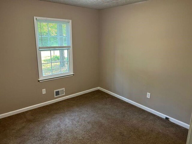 1106 Hardy Cir, Dallas, GA 30157 - unfurnished room with a textured ceiling, baseboards, visible vents, and dark colored carpet