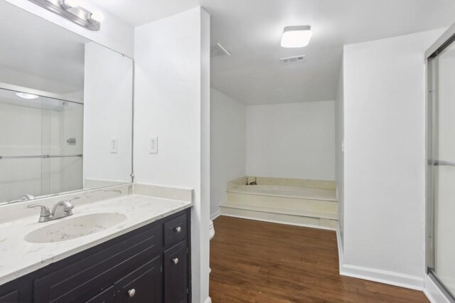 49 Willow Gln, Atlanta, GA 30342 - full bathroom with a shower stall, wood finished floors, vanity, and baseboards
