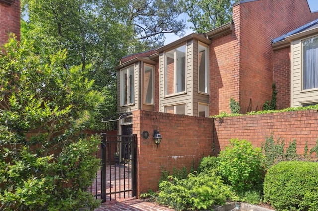 49 Willow Gln, Atlanta, GA 30342 - view of side of home with fence, a gate, and brick siding