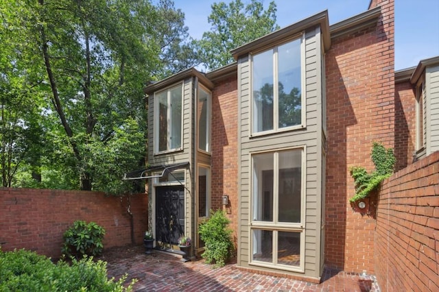 49 Willow Gln, Atlanta, GA 30342 - view of front facade with fence and brick siding