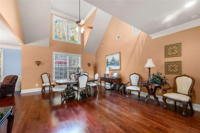 dining room with ornamental molding, high vaulted ceiling, a wealth of natural light, and dark wood-type flooring