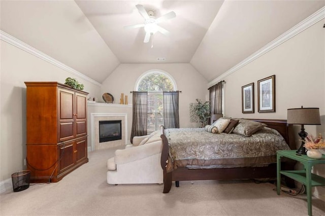 bedroom with light colored carpet, ceiling fan, crown molding, lofted ceiling, and a tiled fireplace