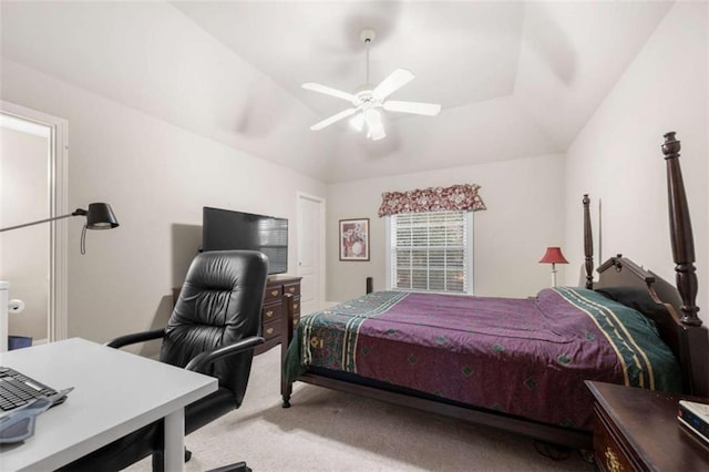 carpeted bedroom with a raised ceiling, ceiling fan, and vaulted ceiling