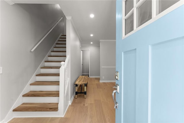 entryway featuring recessed lighting, ornamental molding, stairway, light wood finished floors, and baseboards