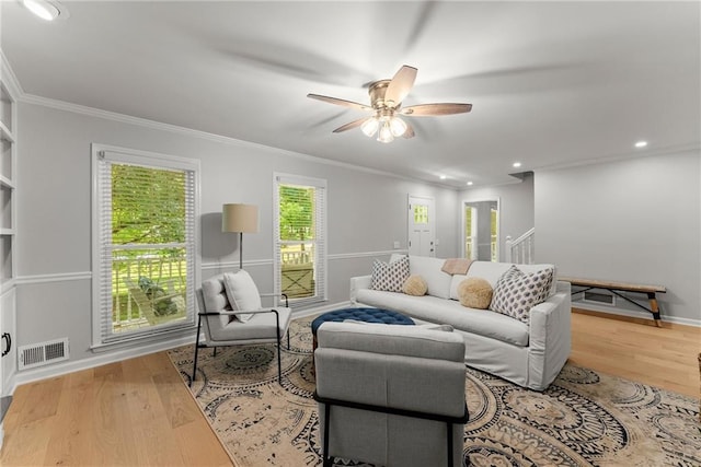 living room featuring ceiling fan, crown molding, wood finished floors, recessed lighting, and baseboards