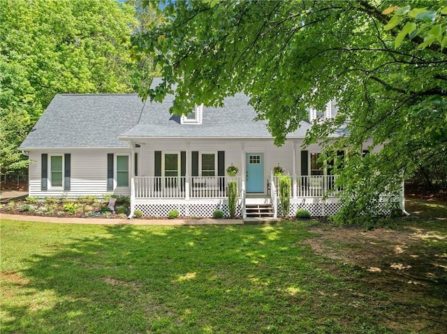 cape cod home with covered porch, a front yard, and roof with shingles