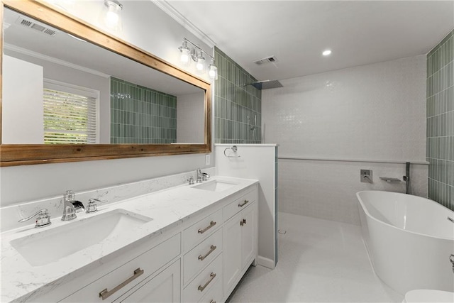 bathroom with a walk in shower, a freestanding tub, double vanity, and crown molding